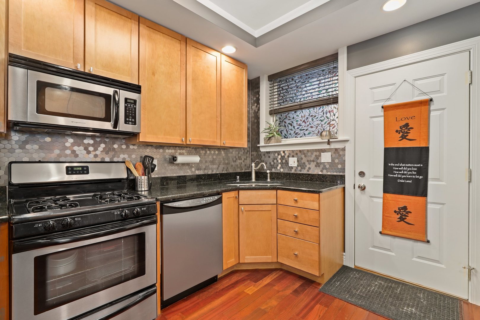 528 West Cornelia Avenue, Unit 2N Chicago, IL 60657 - Photo 7 of 19 a kitchen with stainless steel appliances granite countertop a stove microwave and sink