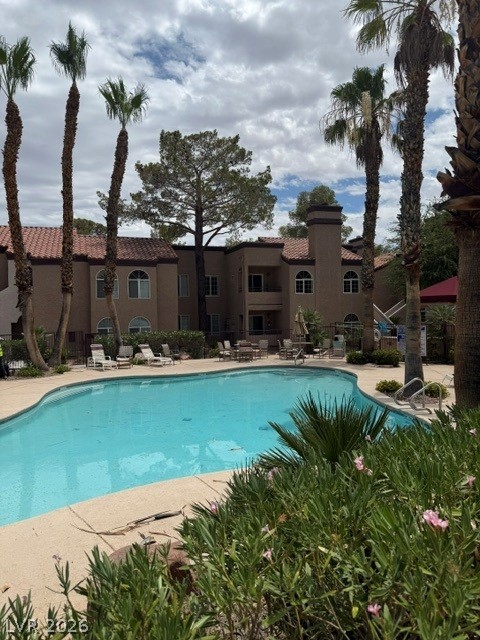 9325 West Desert Inn Road, Unit 278 Las Vegas, NV 89117 - Photo 14 of 17 Enjoy poolside relaxation with mature palm trees and lush landscaping.