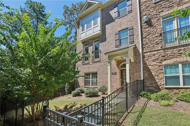 front view of a brick house with a small yard