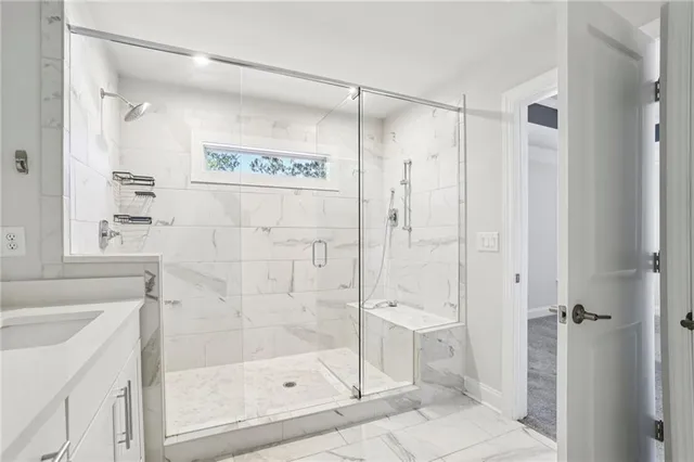 a bathroom with a shower and a sink