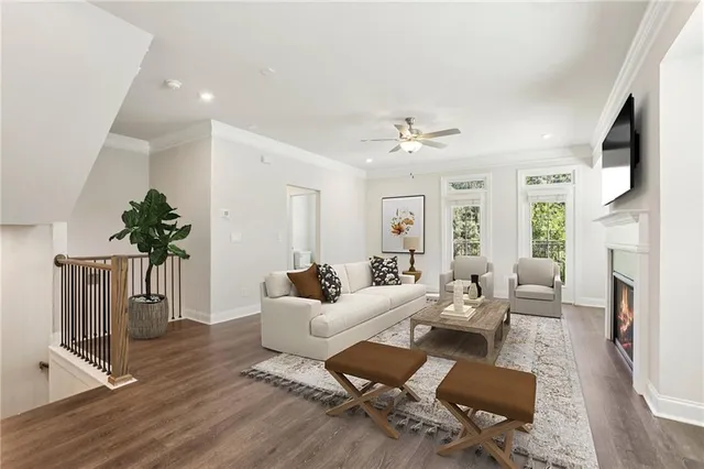a living room with fireplace furniture and a wooden floor