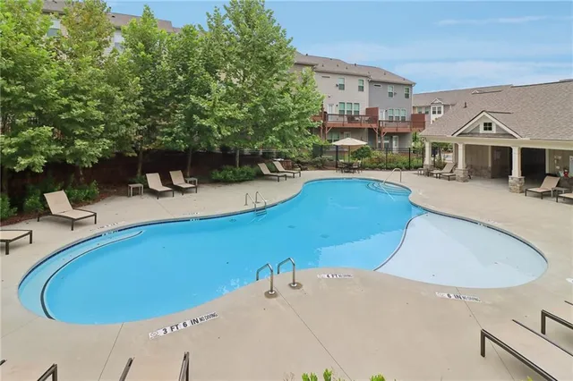 a view of a patio with table and chairs potted plants with wooden fence