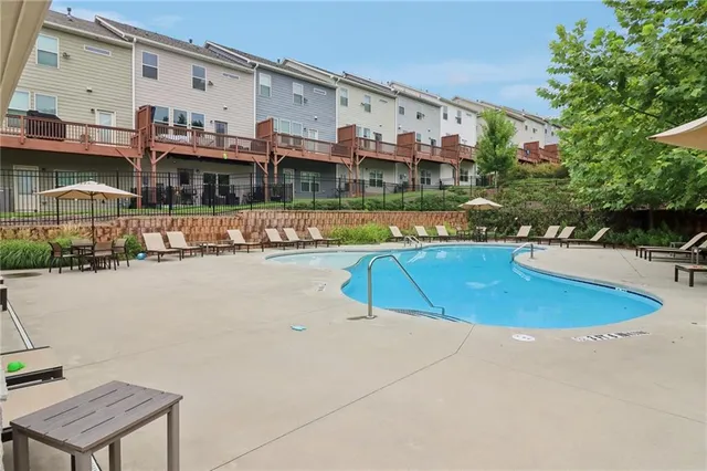 swimming pool view with a seating space