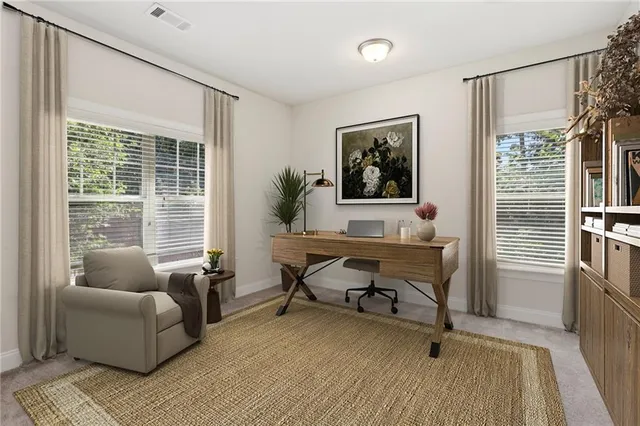 a view of a livingroom with workspace and a couch