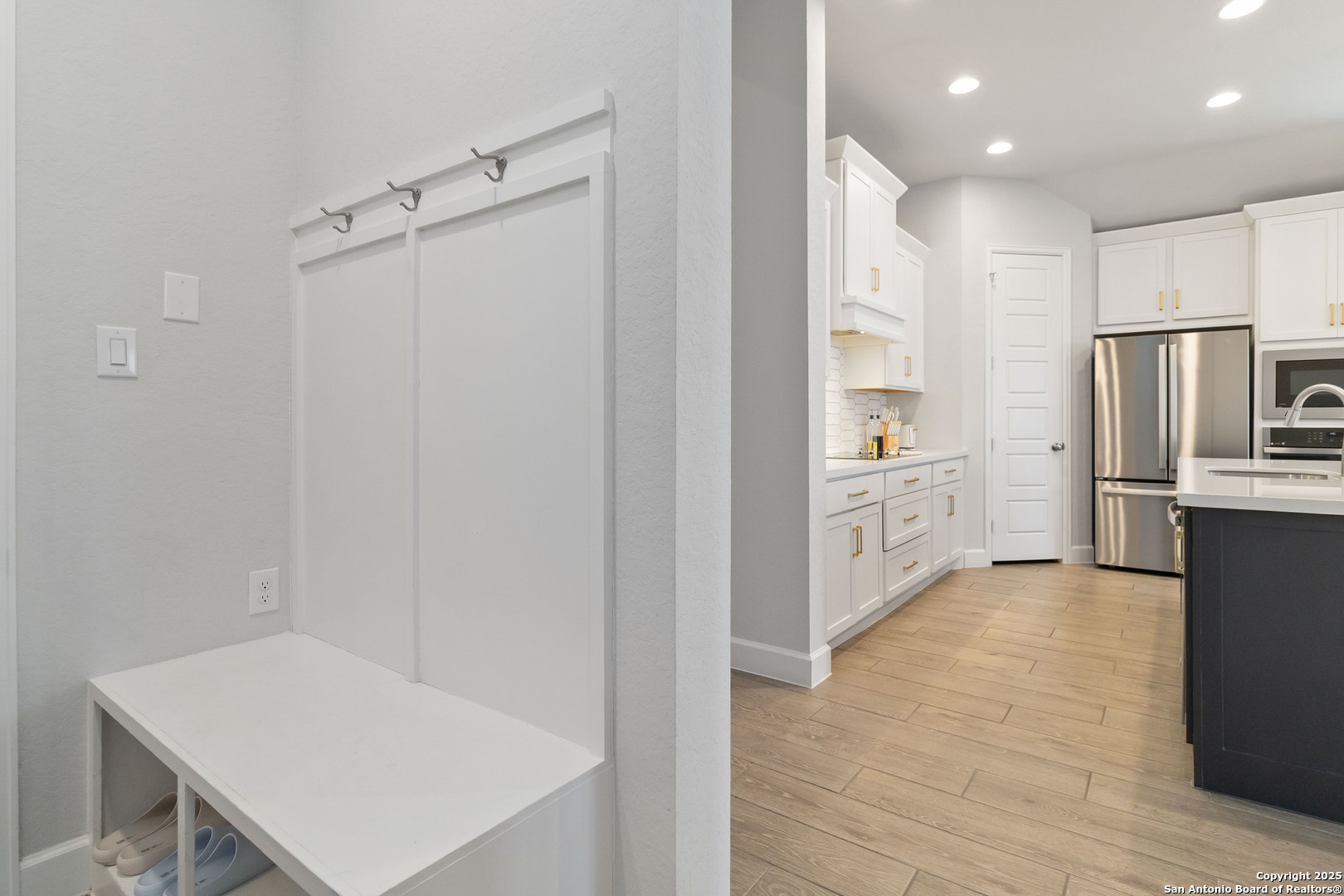 149 Red Oak Castroville, TX 78009 - Photo 13 of 16 a kitchen with white cabinets and refrigerator