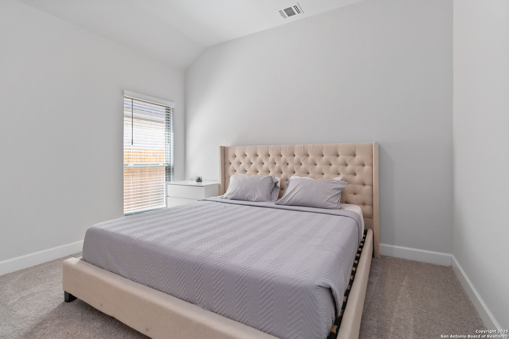 149 Red Oak Castroville, TX 78009 - Photo 14 of 16 a bedroom with a bed and a window