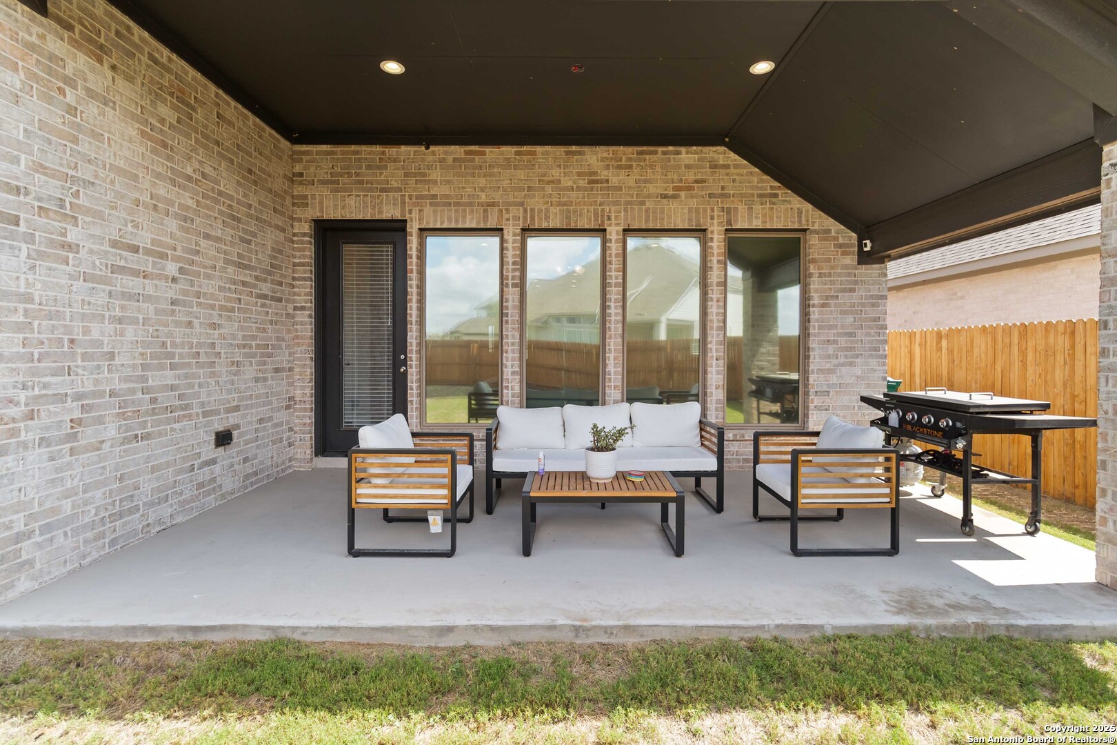 149 Red Oak Castroville, TX 78009 - Photo 16 of 16 a living room with furniture and a floor to ceiling window