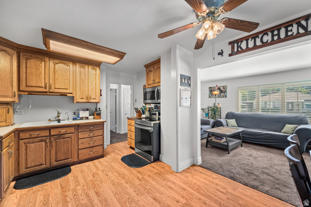 31 B Street Springville, UT 84663 - Photo 7 of 31 Kitchen featuring wood-finish flooring, wood cabinetry, built-in stainless steel appliances, and a ceiling fan with integrated lighting