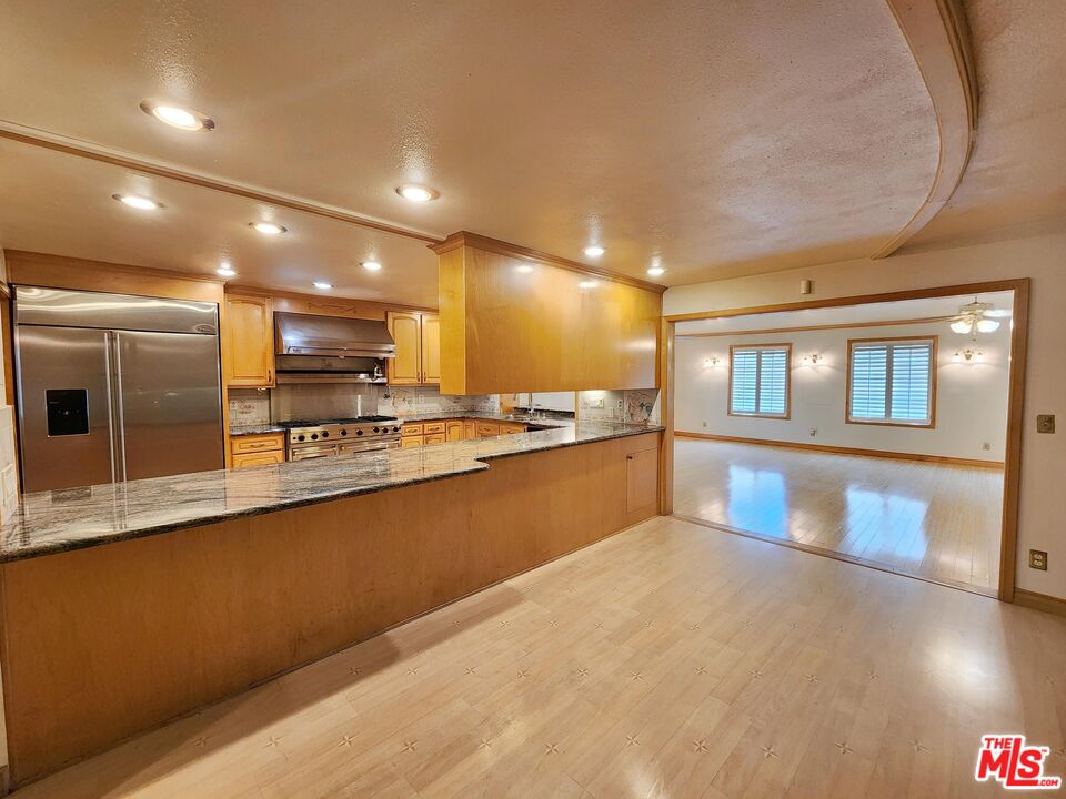 19002 Grandee Avenue Carson, CA 90746 - Photo 14 of 42 a large kitchen with kitchen island a large counter space a sink appliances and cabinets