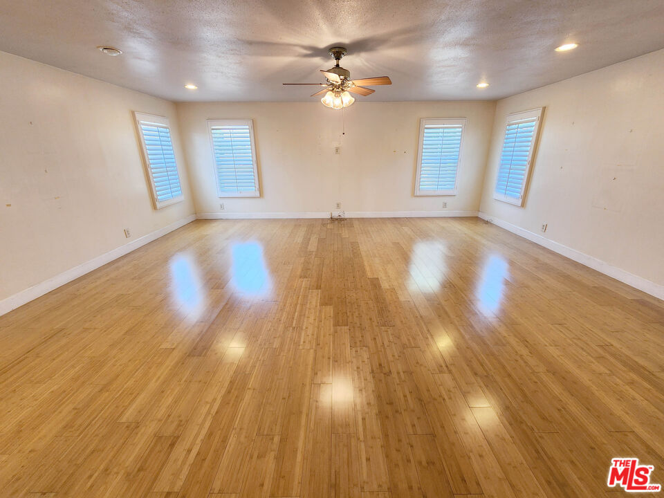 19002 Grandee Avenue Carson, CA 90746 - Photo 24 of 42 a view of an empty room with wooden floor and a ceiling fan