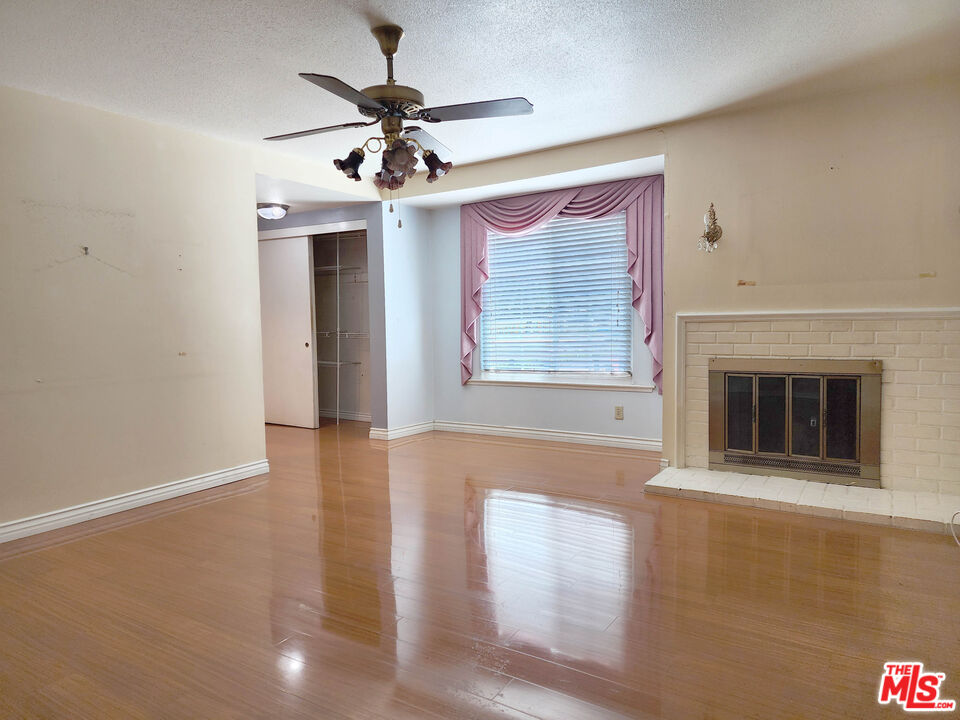 19002 Grandee Avenue Carson, CA 90746 - Photo 31 of 42 a view of an empty room with chandelier fan and fire place