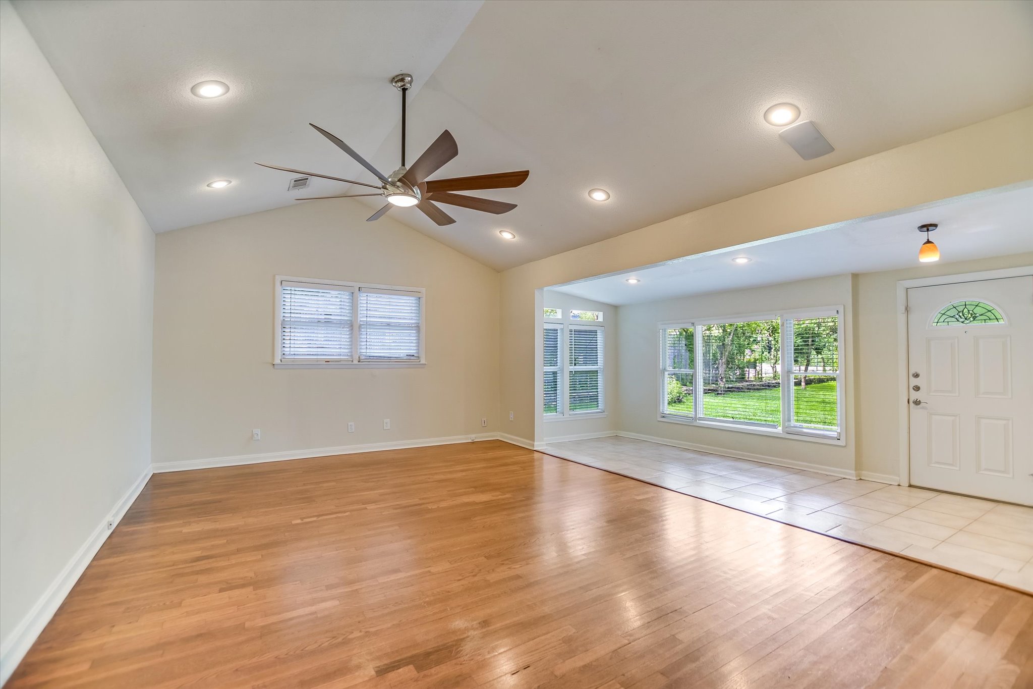 208 Braeswood Road Austin, TX 78704 - Photo 6 of 20 A grand entrance welcomes guests, featuring vaulted ceilings and sun-filled interiors with rich wood flooring.
