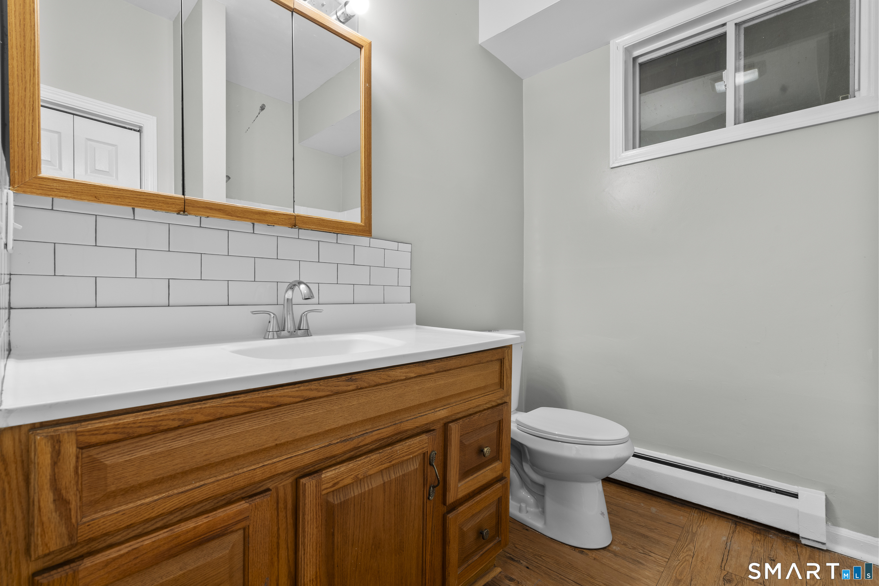 1847 Glasgo Road Griswold, CT 06351 - Photo 12 of 38 a bathroom with a sink a toilet and mirror