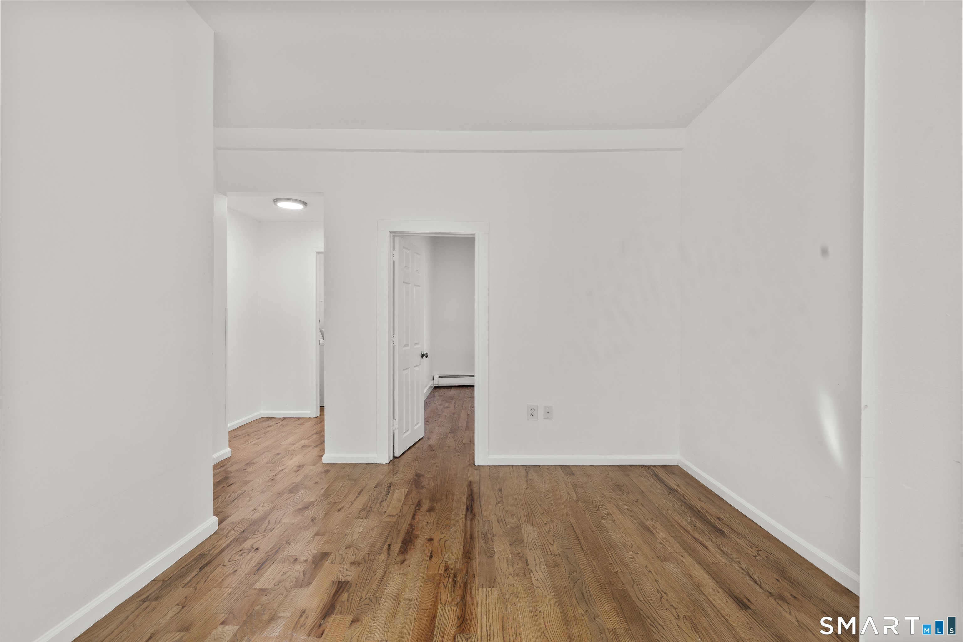 1847 Glasgo Road Griswold, CT 06351 - Photo 15 of 38 a view of a room with wooden floor and white walls