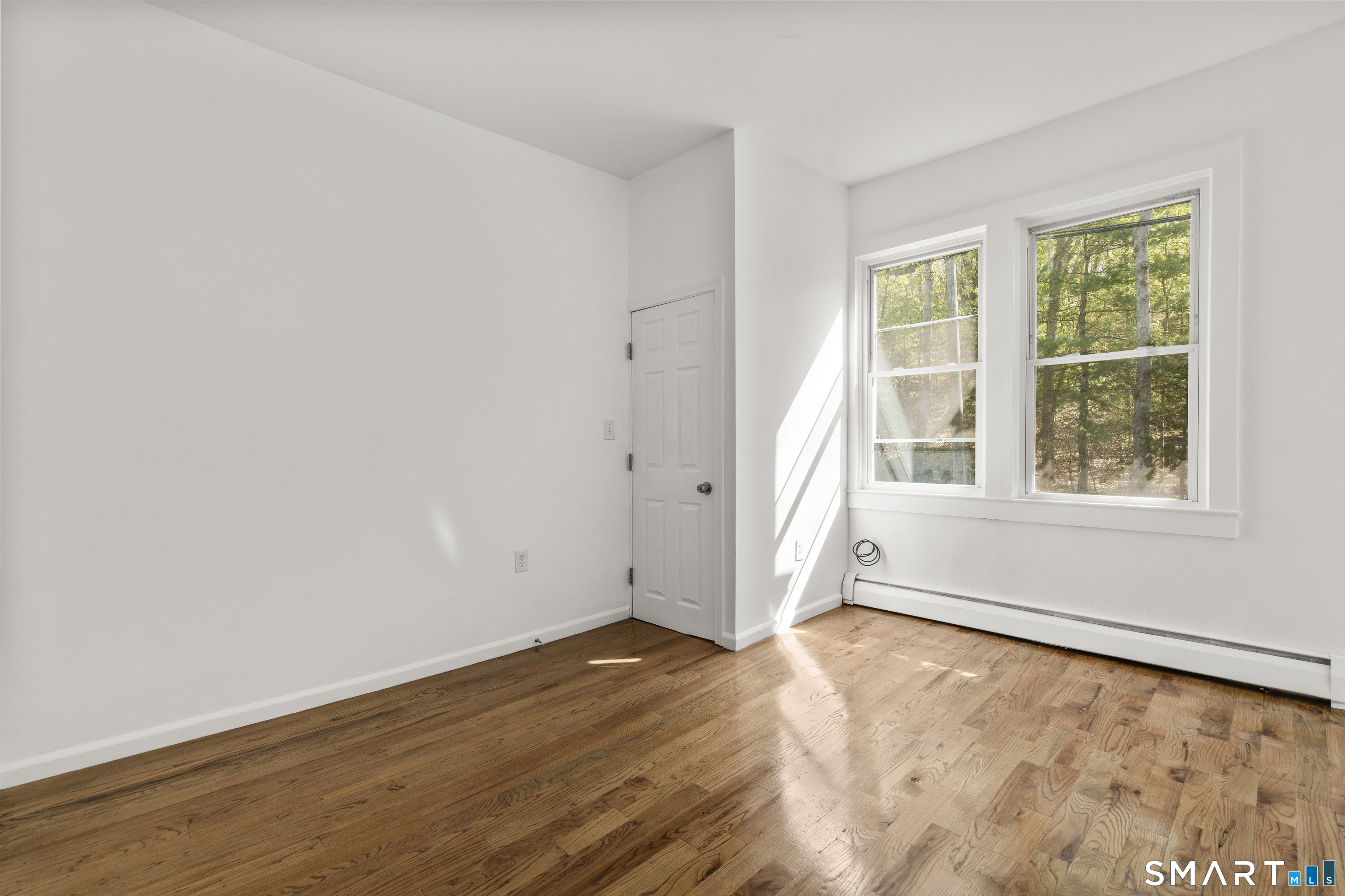 1847 Glasgo Road Griswold, CT 06351 - Photo 16 of 38 an empty room with wooden floor and windows