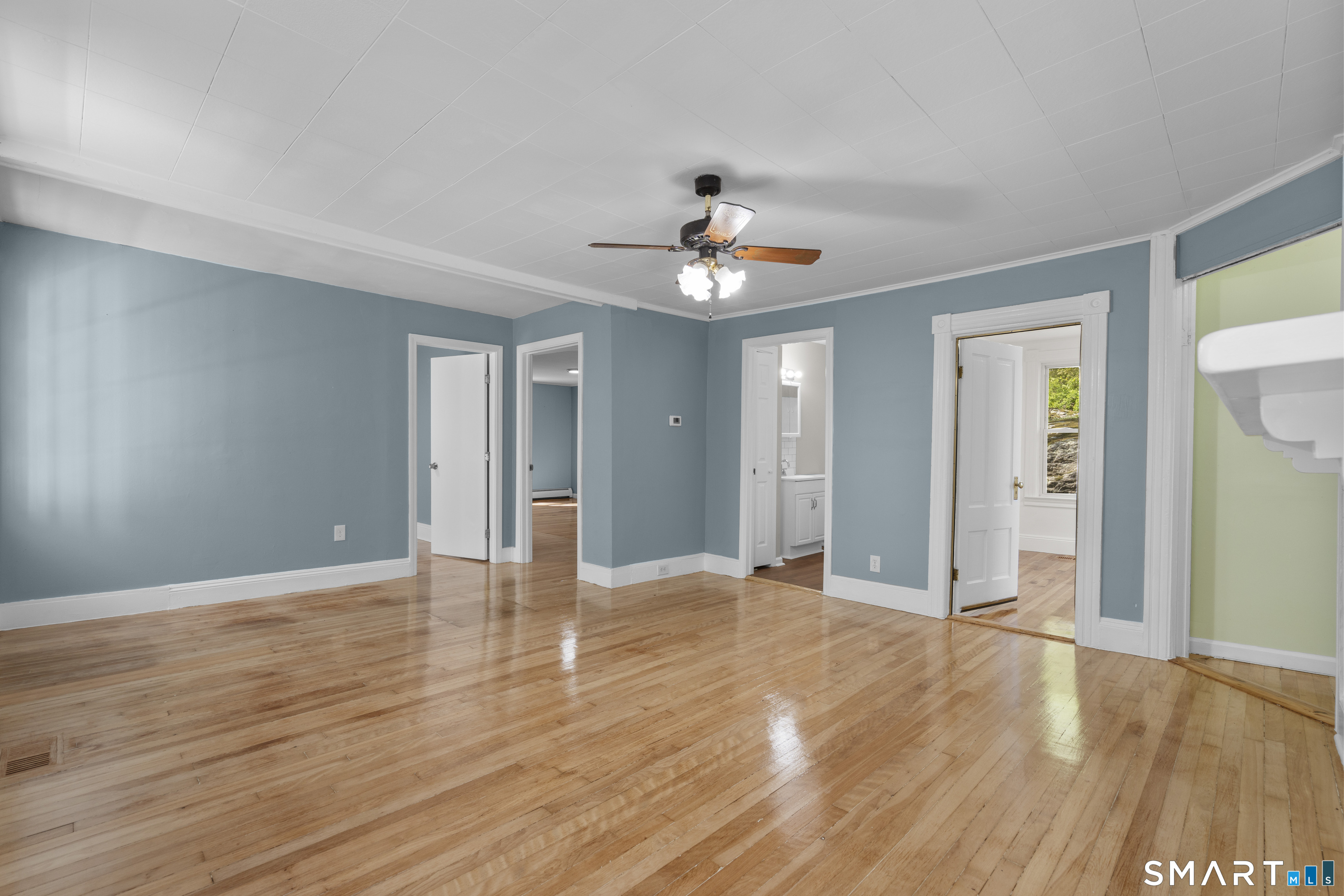 1847 Glasgo Road Griswold, CT 06351 - Photo 19 of 38 a view of an empty room with window and wooden floor