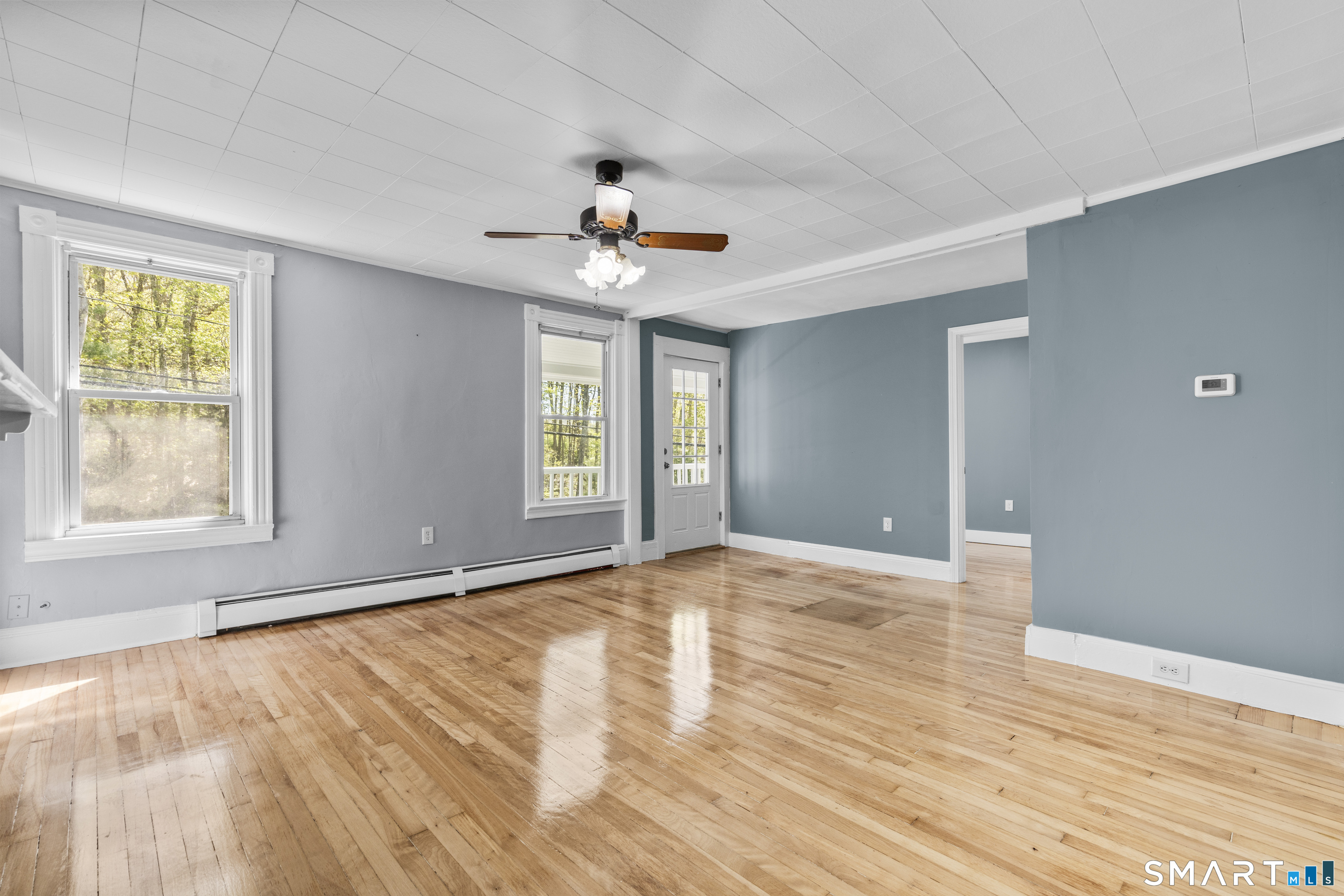 1847 Glasgo Road Griswold, CT 06351 - Photo 20 of 38 a view of an empty room with a window and wooden floor