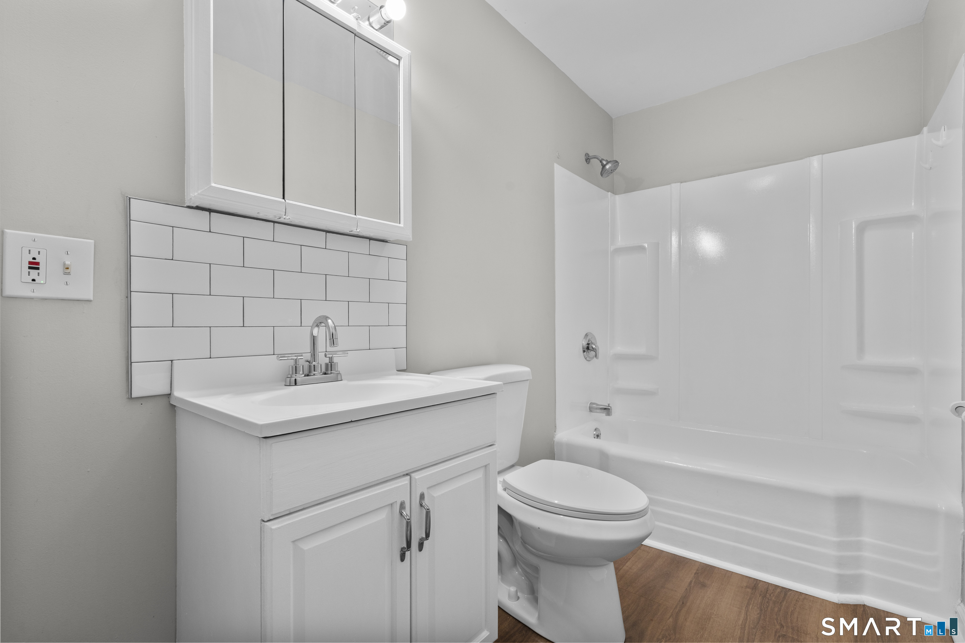 1847 Glasgo Road Griswold, CT 06351 - Photo 25 of 38 a bathroom with a toilet sink vanity tub and shower