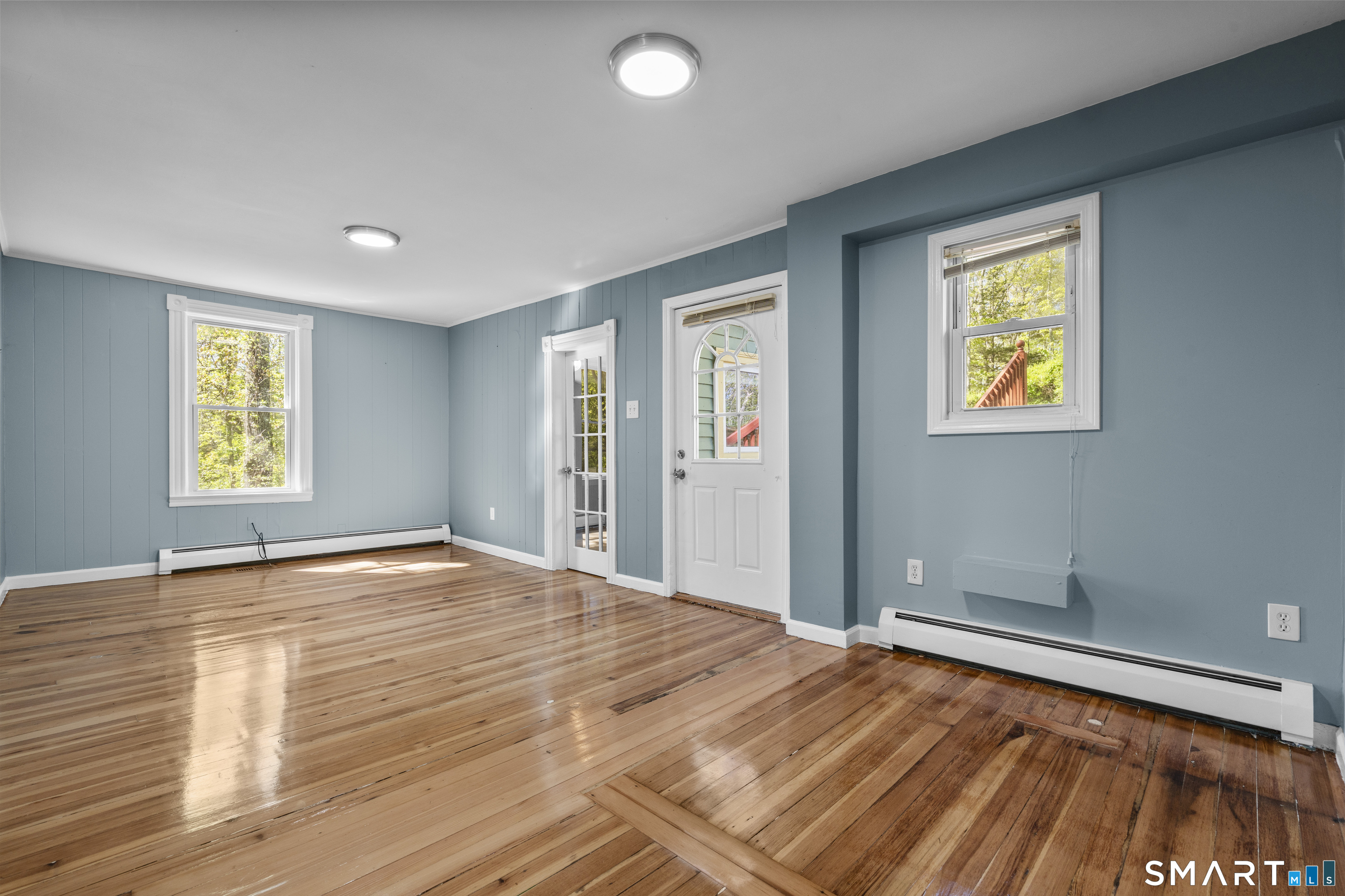 1847 Glasgo Road Griswold, CT 06351 - Photo 30 of 38 a view of an empty room with window and wooden floor