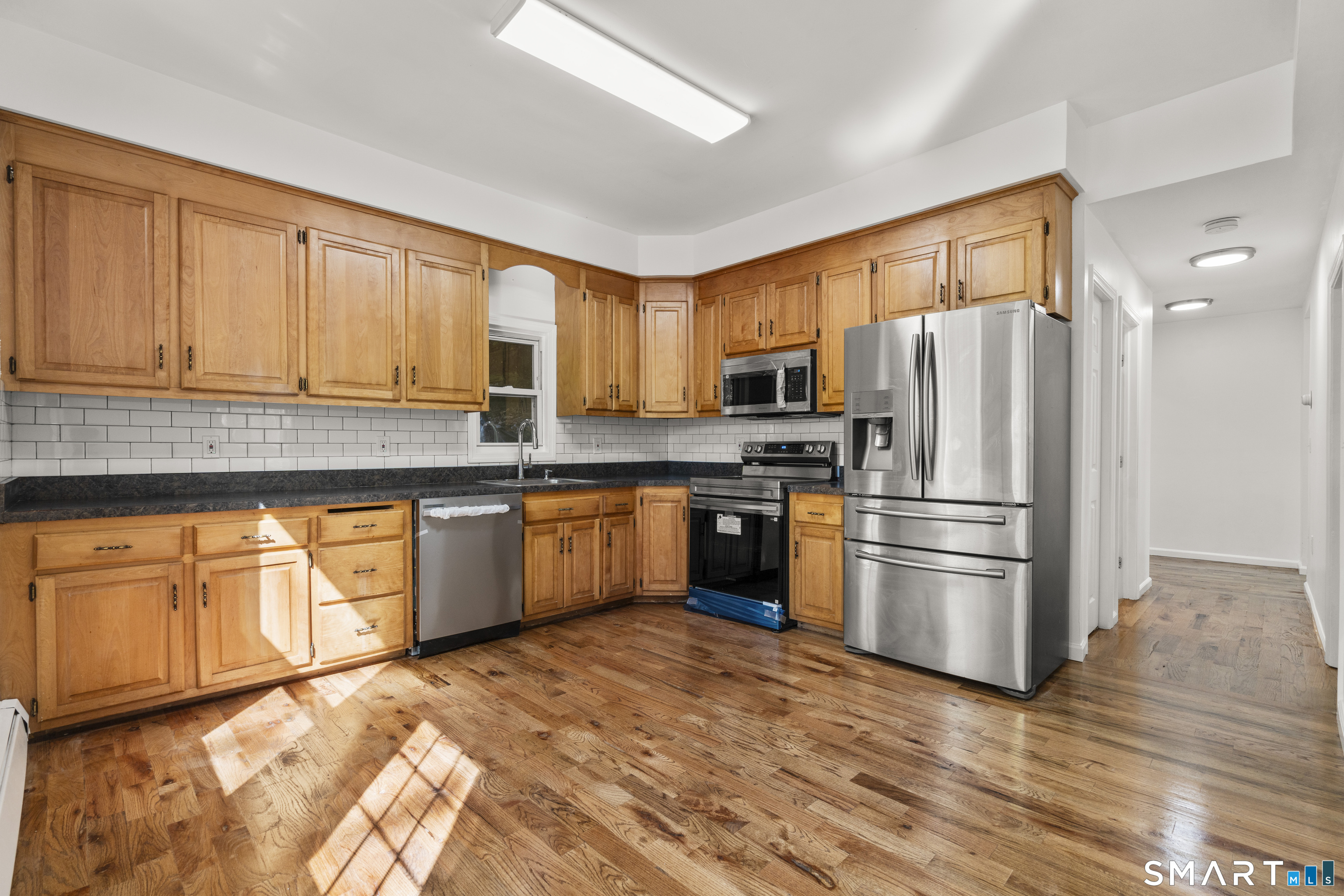 1847 Glasgo Road Griswold, CT 06351 - Photo 3 of 38 a kitchen with granite countertop a refrigerator stove top oven and sink