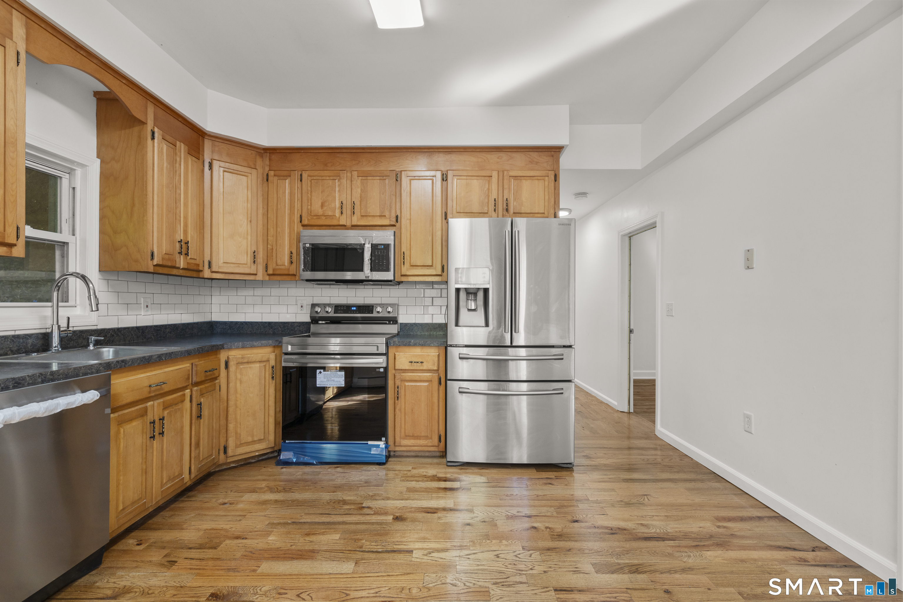 1847 Glasgo Road Griswold, CT 06351 - Photo 4 of 38 a kitchen with granite countertop a stove top oven and refrigerator