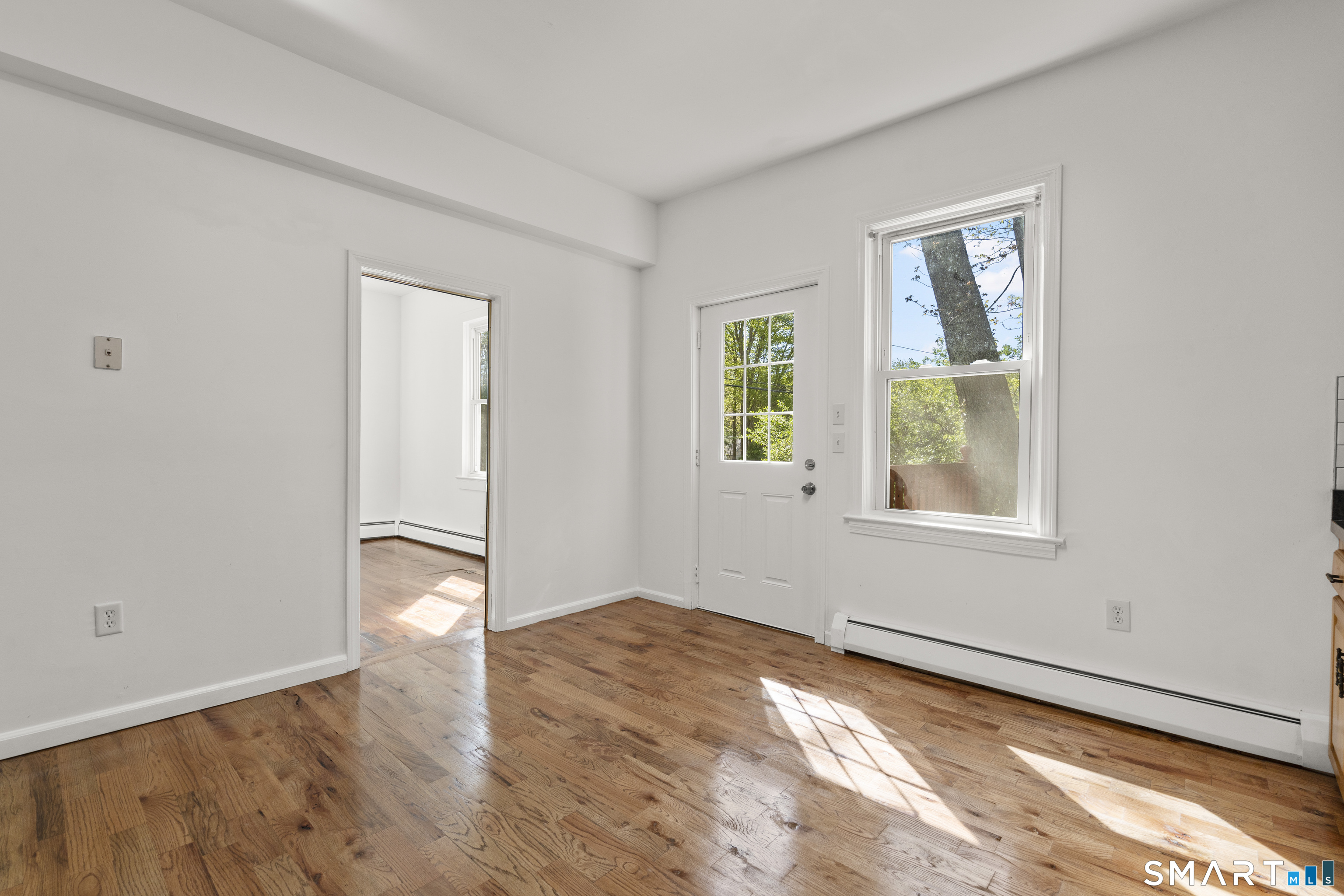1847 Glasgo Road Griswold, CT 06351 - Photo 5 of 38 an empty room with wooden floor and windows