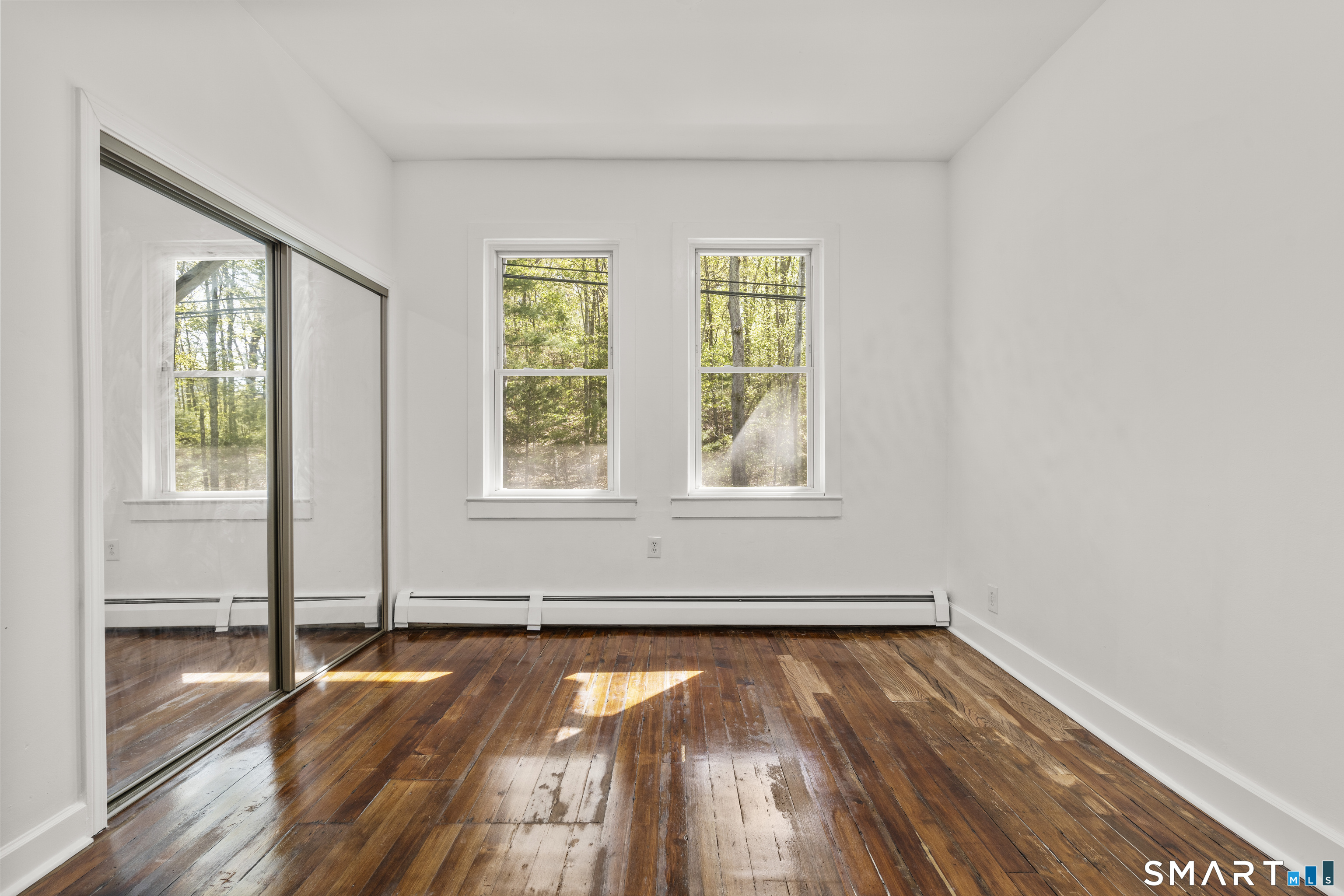 1847 Glasgo Road Griswold, CT 06351 - Photo 8 of 38 an empty room with wooden floor and windows