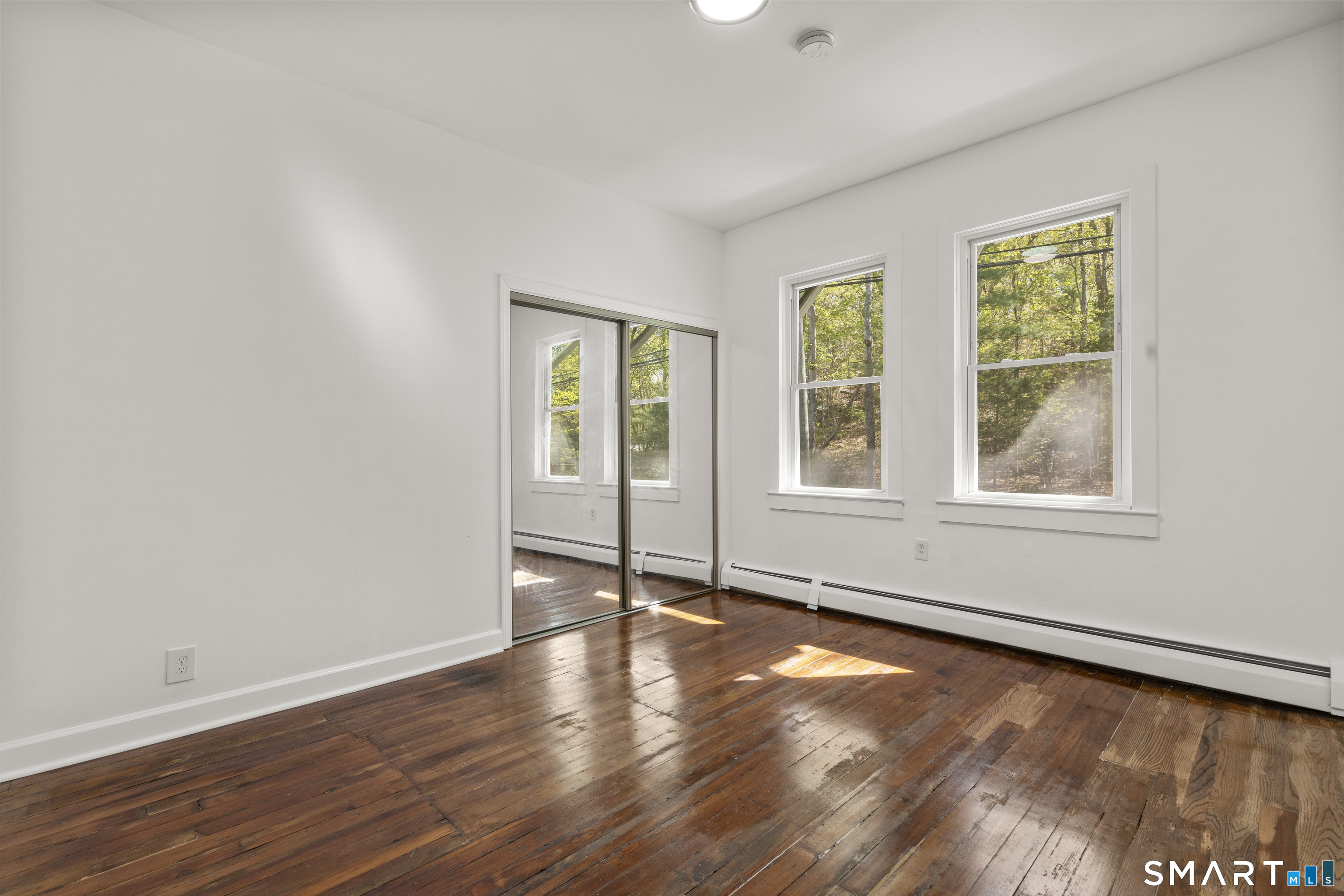 1847 Glasgo Road Griswold, CT 06351 - Photo 9 of 38 a view of an empty room with wooden floor and a window