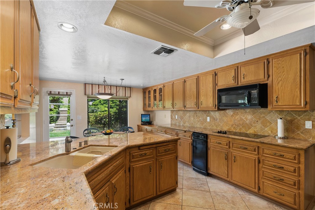 2376 North Vallejo Way Upland, CA 91784 - Photo 13 of 37 a large kitchen with stainless steel appliances granite countertop a sink and cabinets