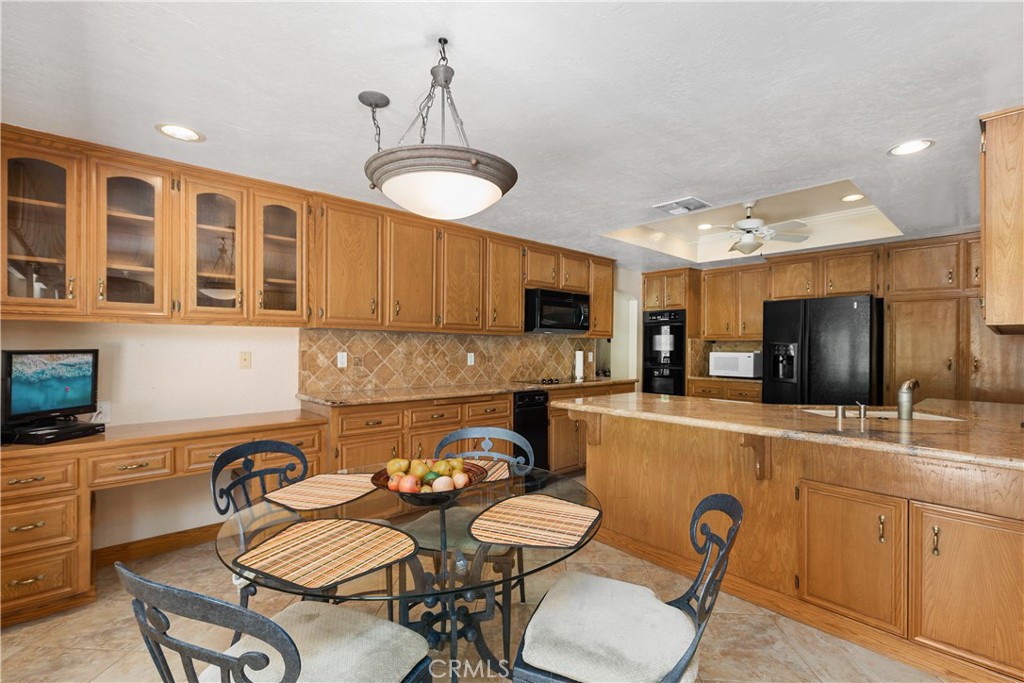 2376 North Vallejo Way Upland, CA 91784 - Photo 15 of 37 a kitchen with stainless steel appliances kitchen island granite countertop a sink a stove a refrigerator cabinets and chairs