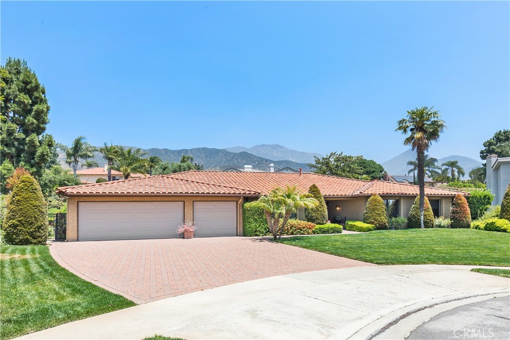 2376 North Vallejo Way Upland, CA 91784 - Photo 2 of 37 a front view of a house with a yard and garage