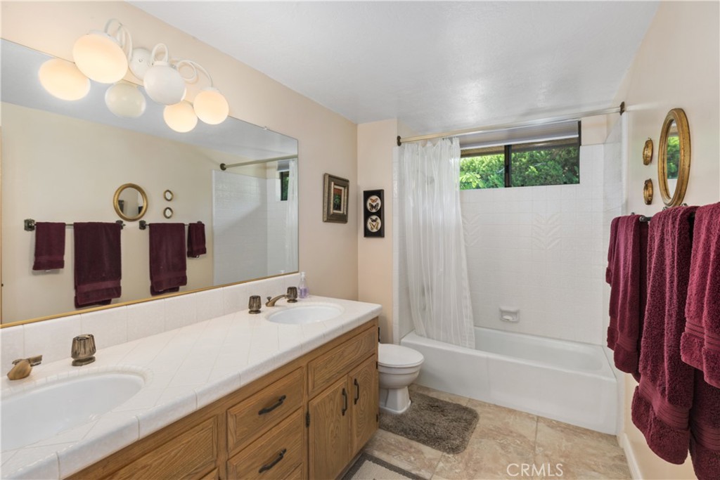 2376 North Vallejo Way Upland, CA 91784 - Photo 25 of 37 a bathroom with a tub sink and mirror