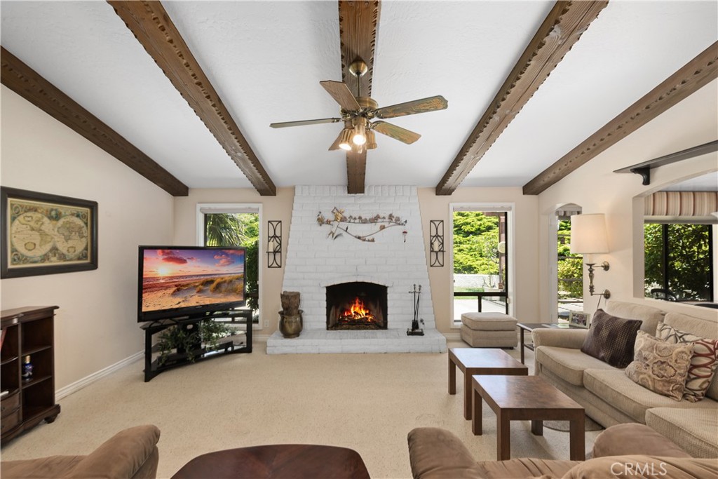 2376 North Vallejo Way Upland, CA 91784 - Photo 9 of 37 a living room with furniture a flat screen tv and a fireplace
