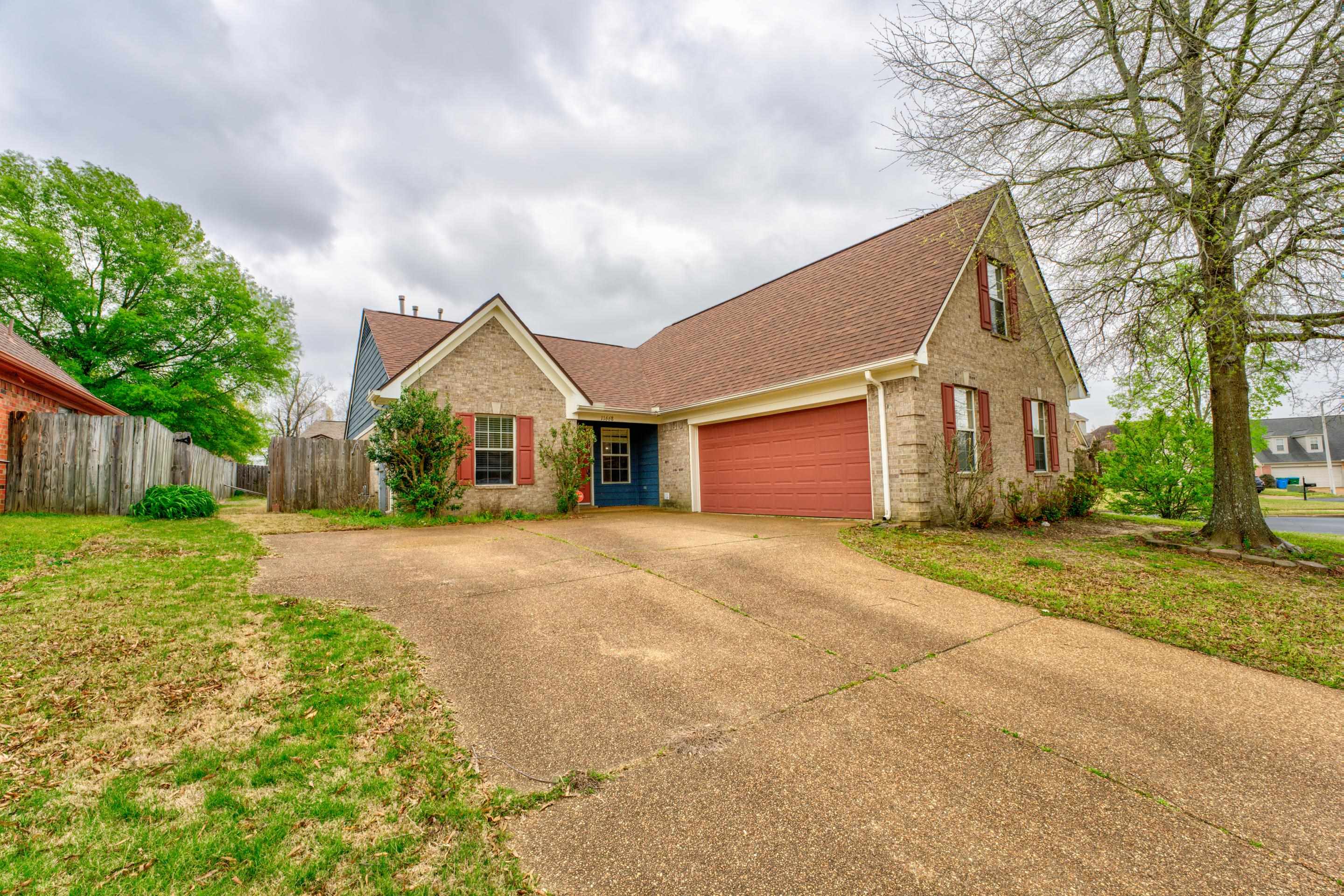 11668 Millwind Drive Arlington, TN 38002 - Photo 1 of 22 a front view of a house with a yard and garage