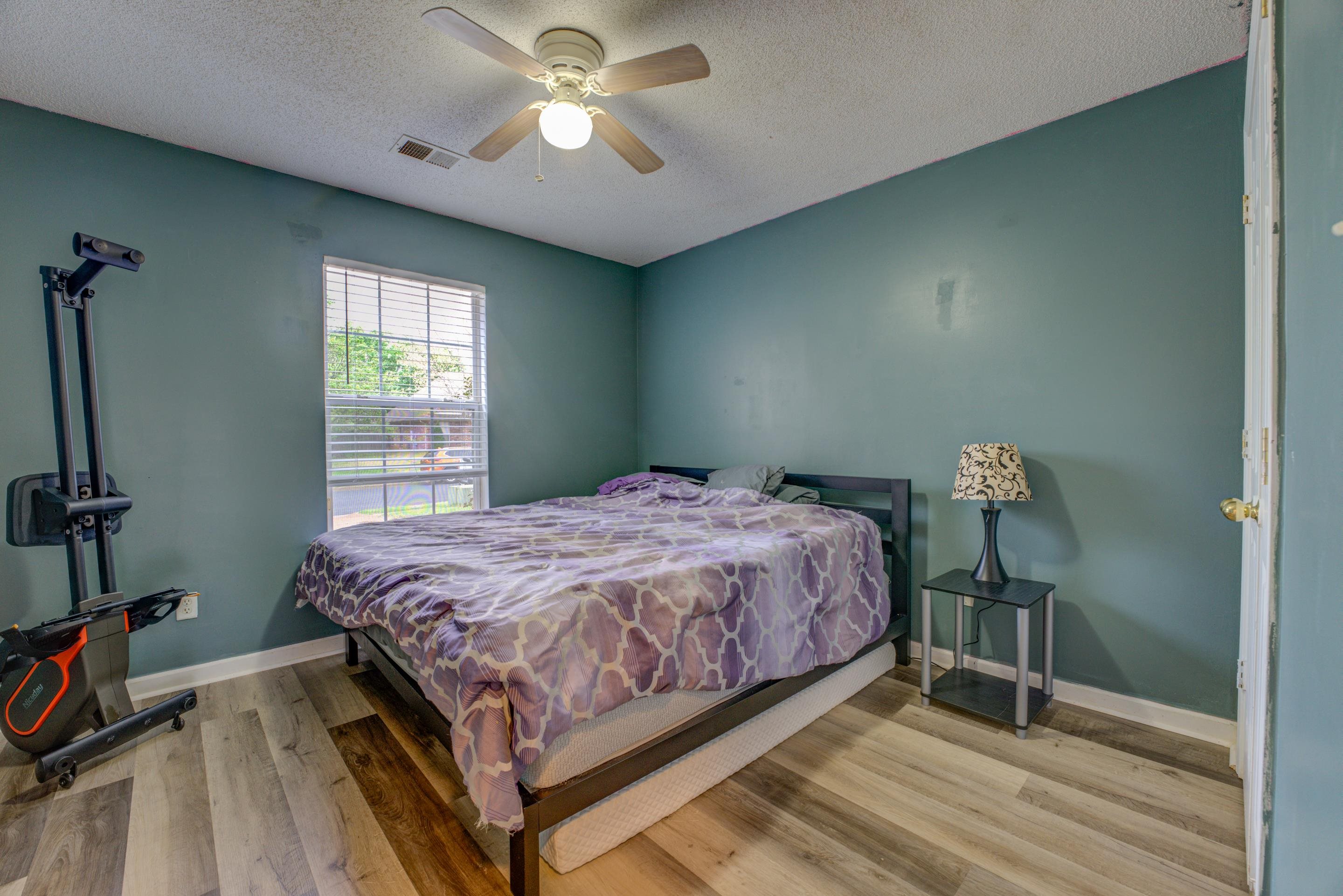 11668 Millwind Drive Arlington, TN 38002 - Photo 11 of 22 a bedroom with a bed and a chandelier