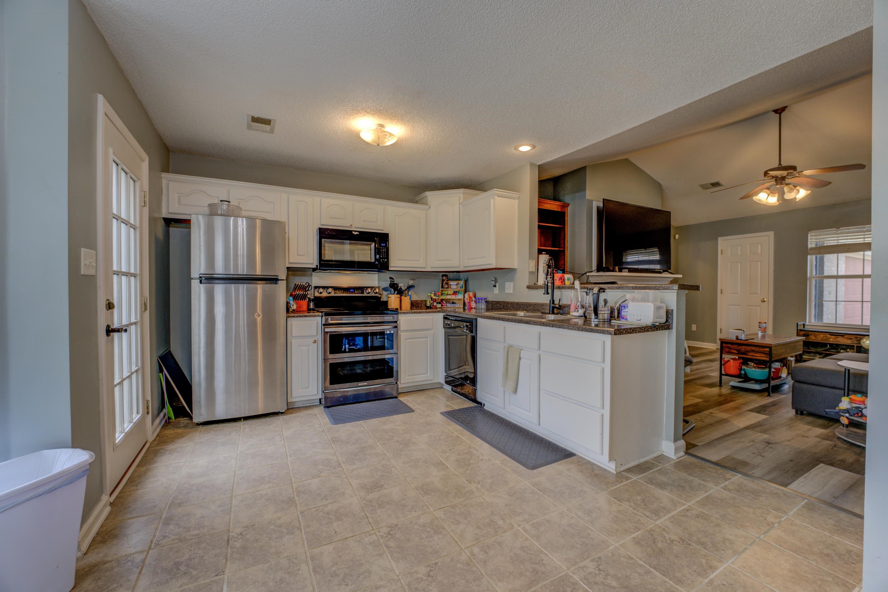 11668 Millwind Drive Arlington, TN 38002 - Photo 2 of 22 a kitchen with refrigerator and cabinets