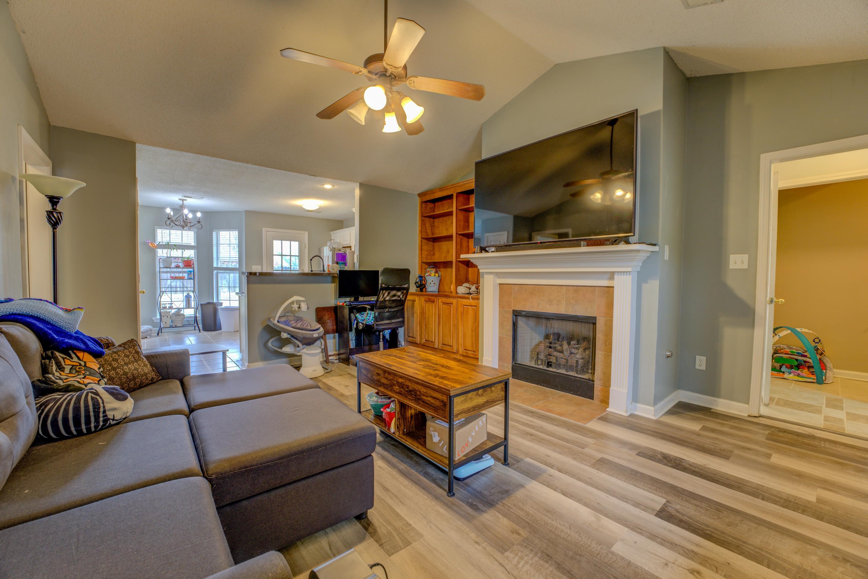 11668 Millwind Drive Arlington, TN 38002 - Photo 3 of 22 a living room with furniture a flat screen tv and a fireplace