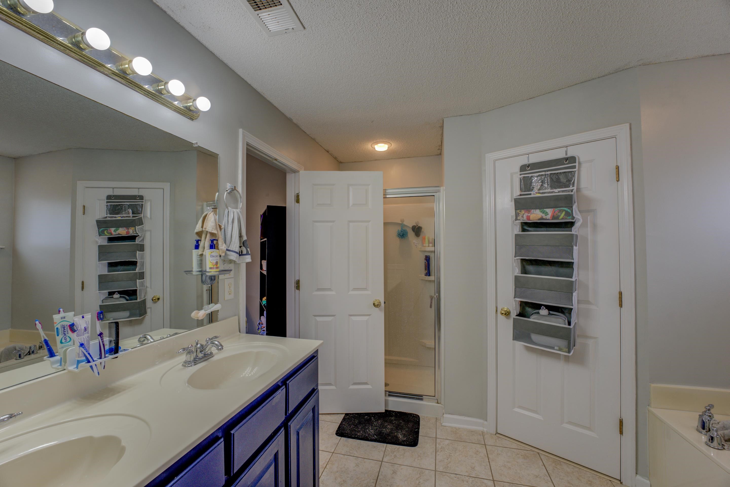11668 Millwind Drive Arlington, TN 38002 - Photo 5 of 22 a bathroom with a sink double vanity and a shower