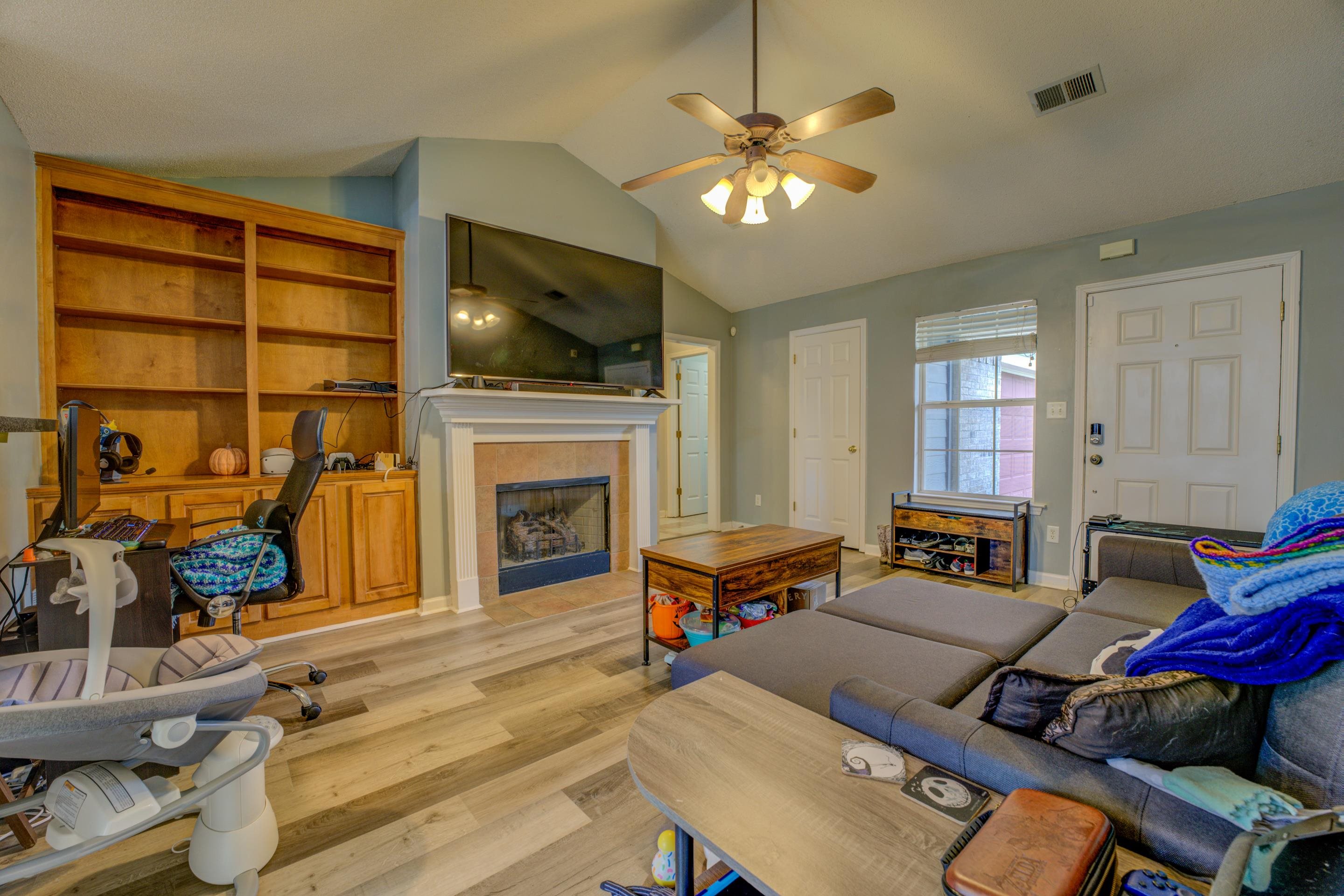 11668 Millwind Drive Arlington, TN 38002 - Photo 10 of 22 a living room with furniture a fireplace and a flat screen tv