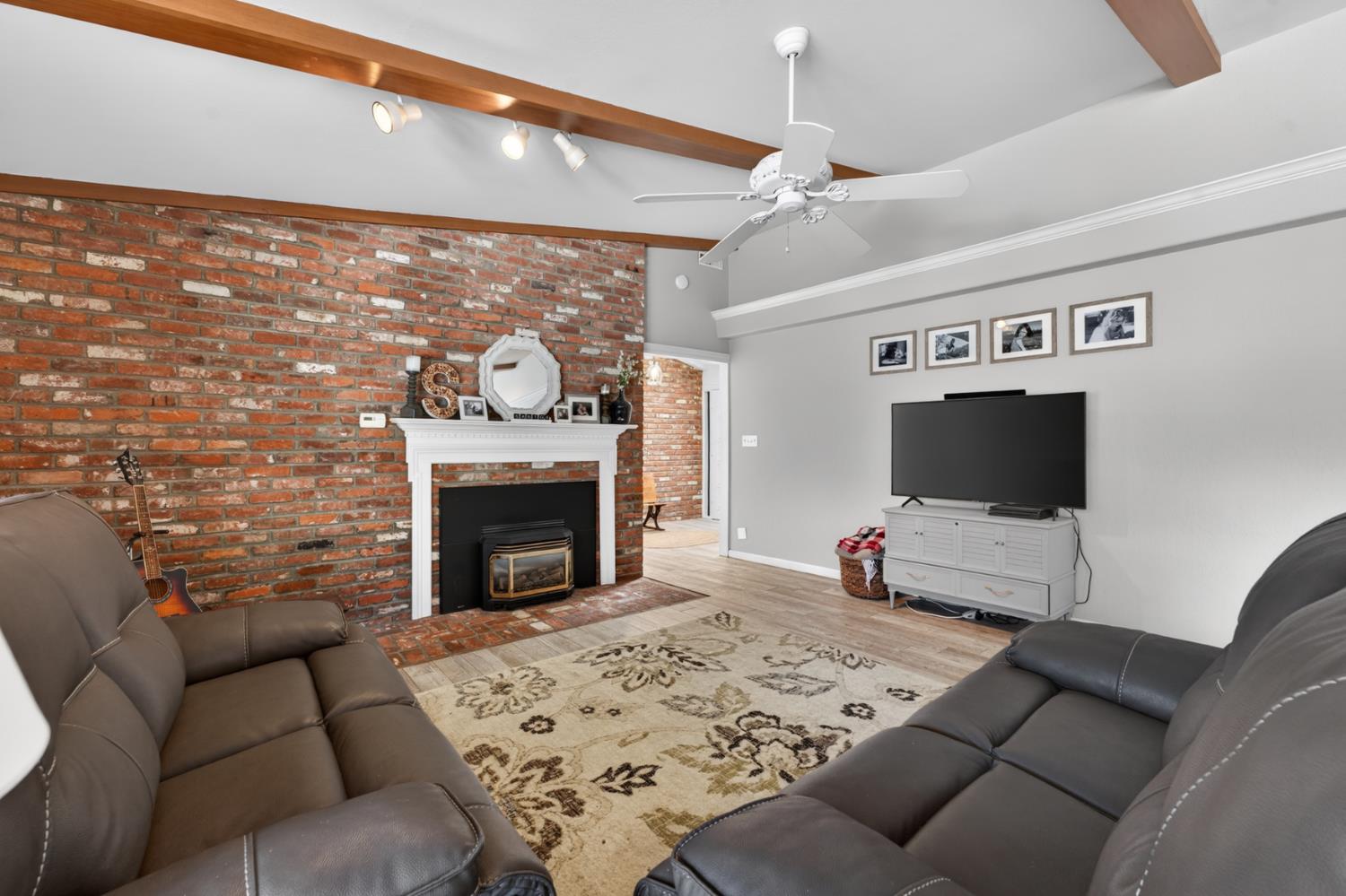 1880 Magnolia Street Gridley, CA 95948 - Photo 14 of 95 a living room with furniture a flat screen tv and a fireplace