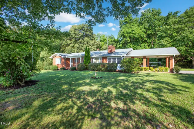 a front view of a house with a yard table and chairs