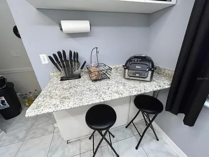 a kitchen with a table and chairs in it