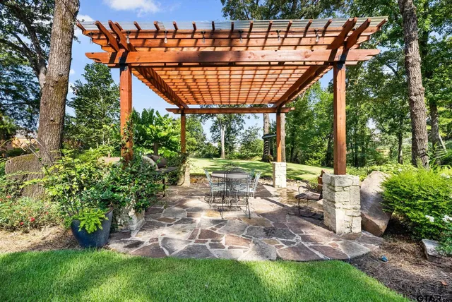 a view of swimming pool with outdoor seating and plants