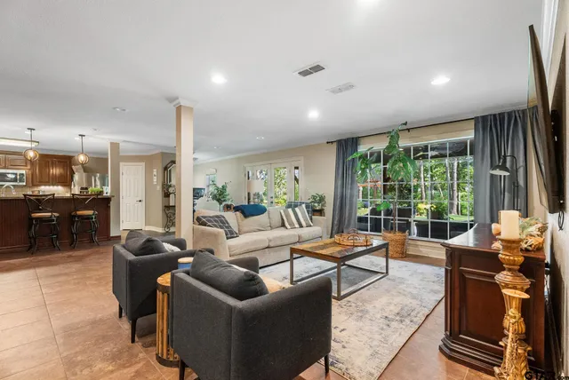 a living room with furniture and a large window