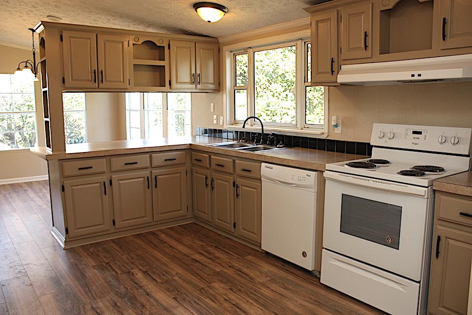 5128 Starks Road Cross Plains, TN 37049 - Photo 12 of 17 a kitchen with stainless steel appliances granite countertop a sink a stove and cabinets