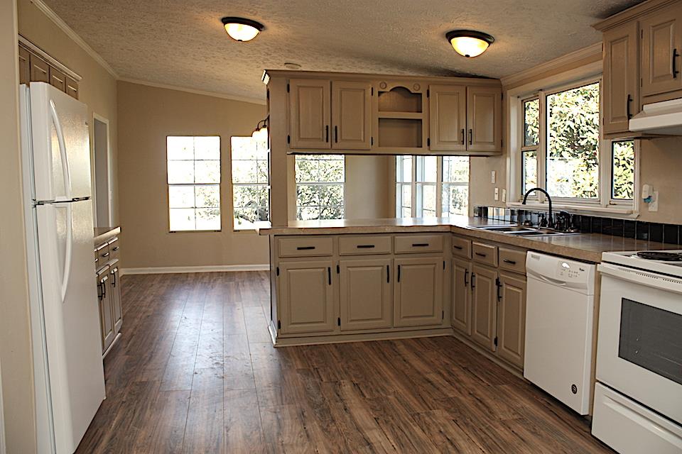 5128 Starks Road Cross Plains, TN 37049 - Photo 13 of 17 a kitchen with a sink wooden floor and windows