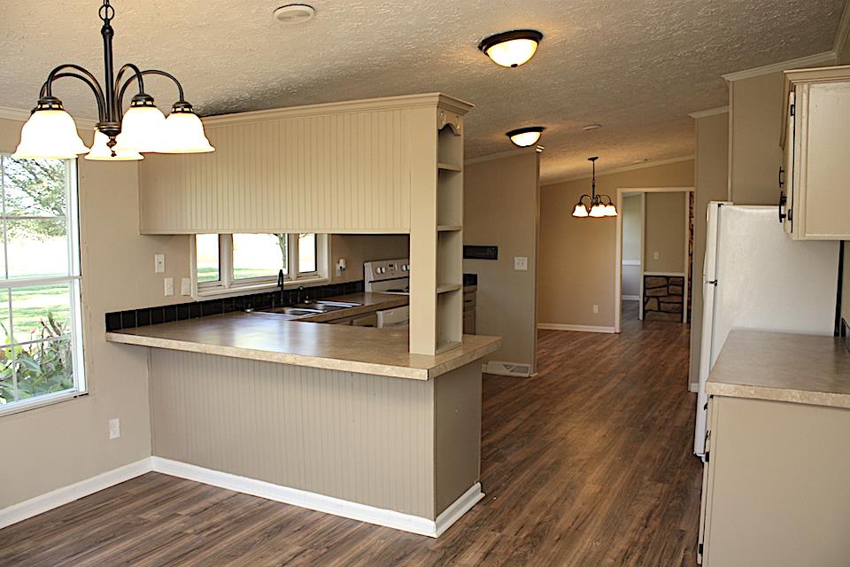 5128 Starks Road Cross Plains, TN 37049 - Photo 14 of 17 a kitchen with stainless steel appliances granite countertop a refrigerator a stove and a wooden floors