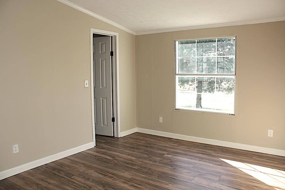 5128 Starks Road Cross Plains, TN 37049 - Photo 15 of 17 an empty room with wooden floor and windows