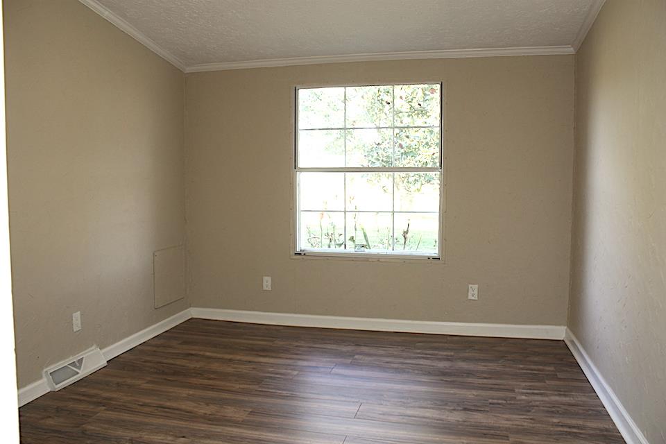 5128 Starks Road Cross Plains, TN 37049 - Photo 17 of 17 an empty room with wooden floor and windows
