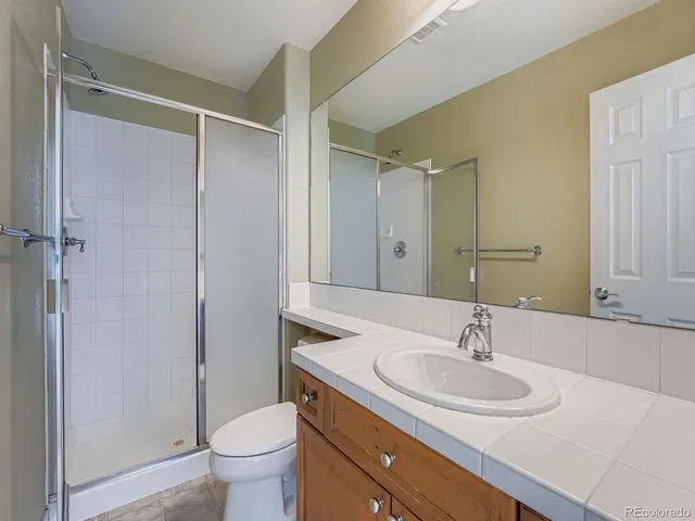 a bathroom with a sink toilet and a mirror